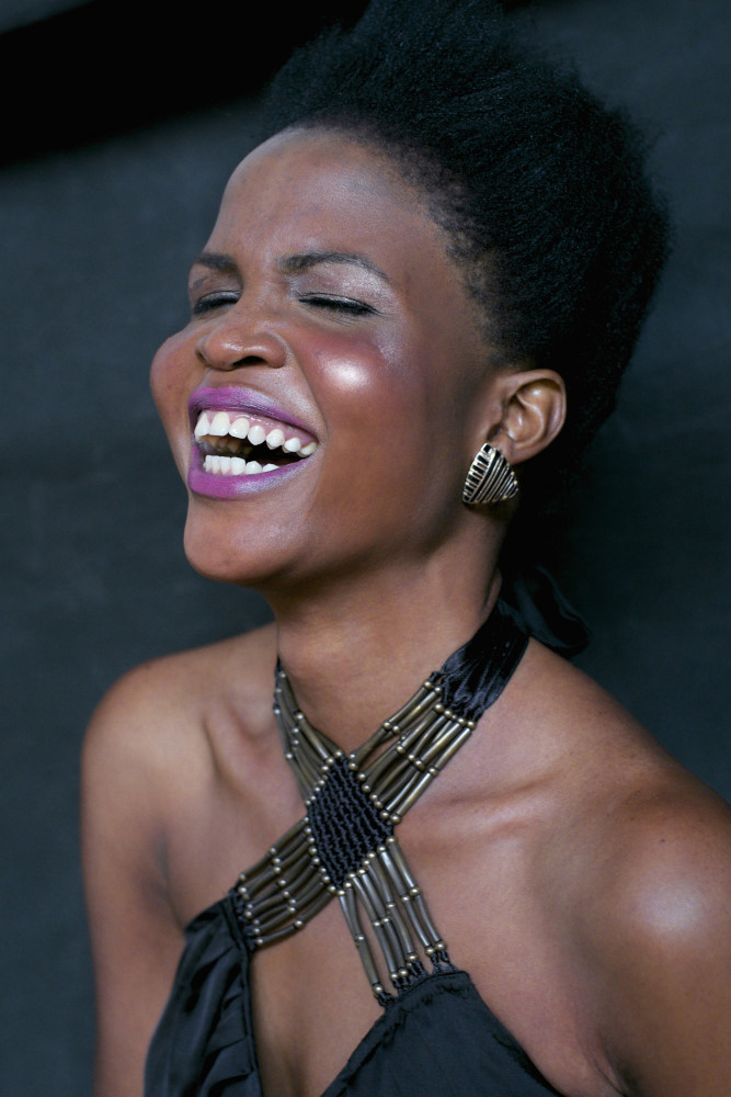 Black african model smiling with eyes closed in the studio. Fashion Headshot by Kent Johnson Photography.