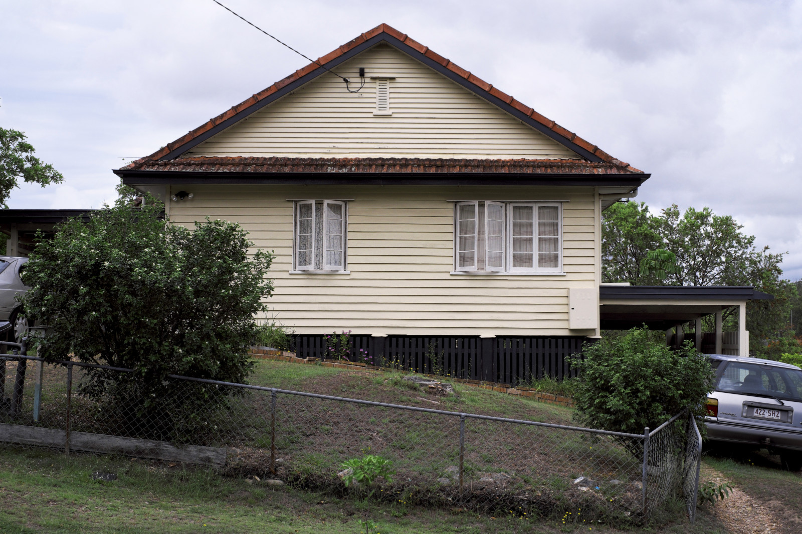 Traditional 40's 50's weatherboard home with casement windows on a sloping block in Carina. Post WW2 Brisbane vernacular architecture.