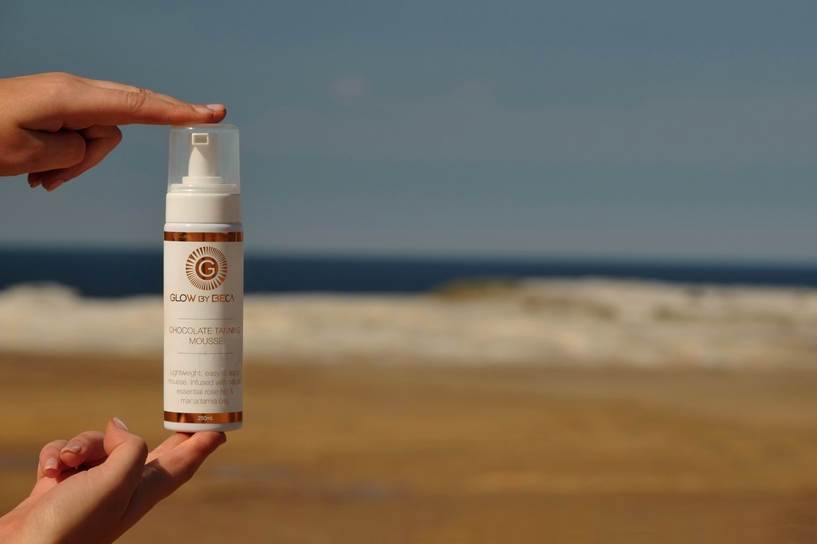 Tanning mousse product shot on Australian beach 