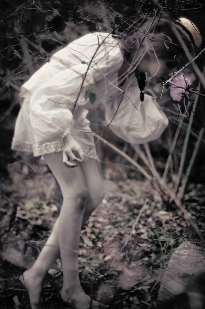 Sydney - Smelling a wildflower in the Australian bush. Editorial Fashion Photography on Location by Kent Johnson, Alice's Dreamtime, Alone In the Bush.