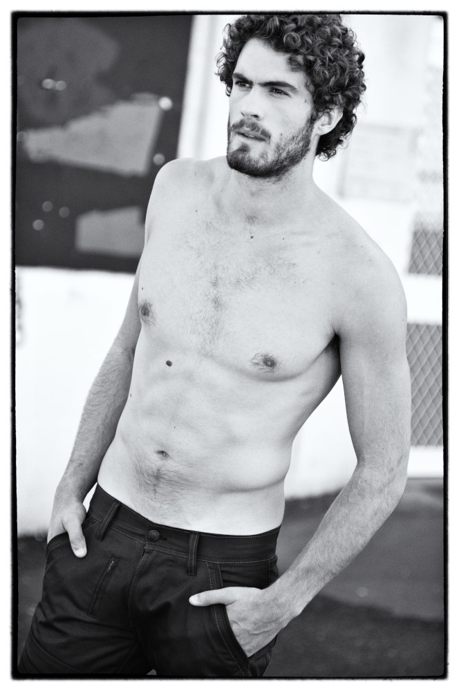 Male model no shirt wearing black denim jeans, on a basketball court, black and white photograph by Kent Johnson, Sydney Australia.