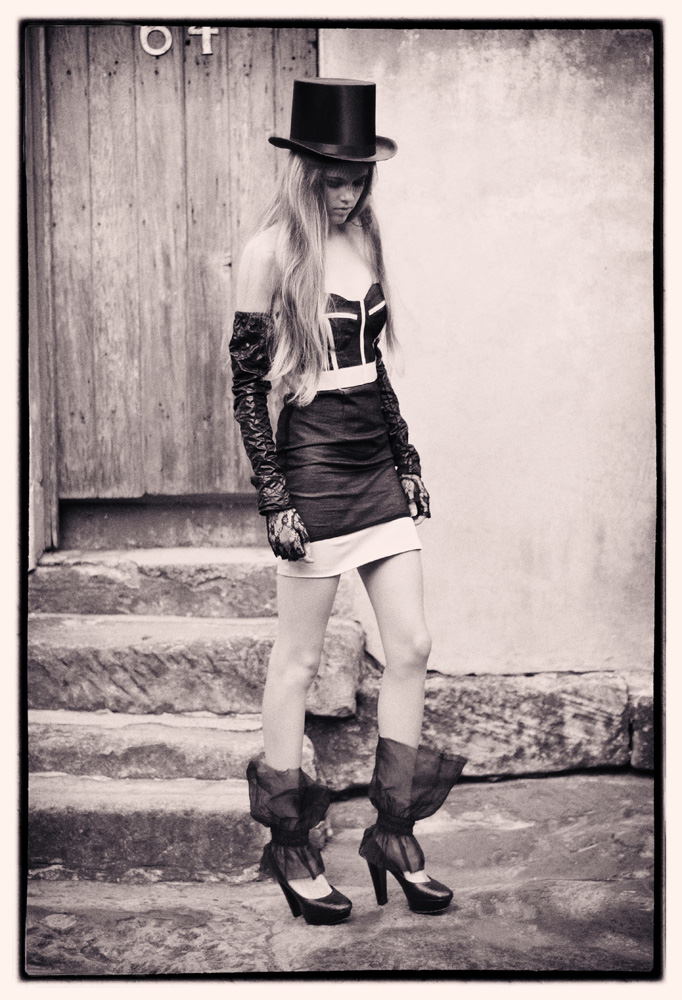 Victoria in top hat, tulle ankle 'socks' skirt and bustier; classic warm toned black and white fashion photograph - photographed on location by Kent Johnson, Sydney, Australia.