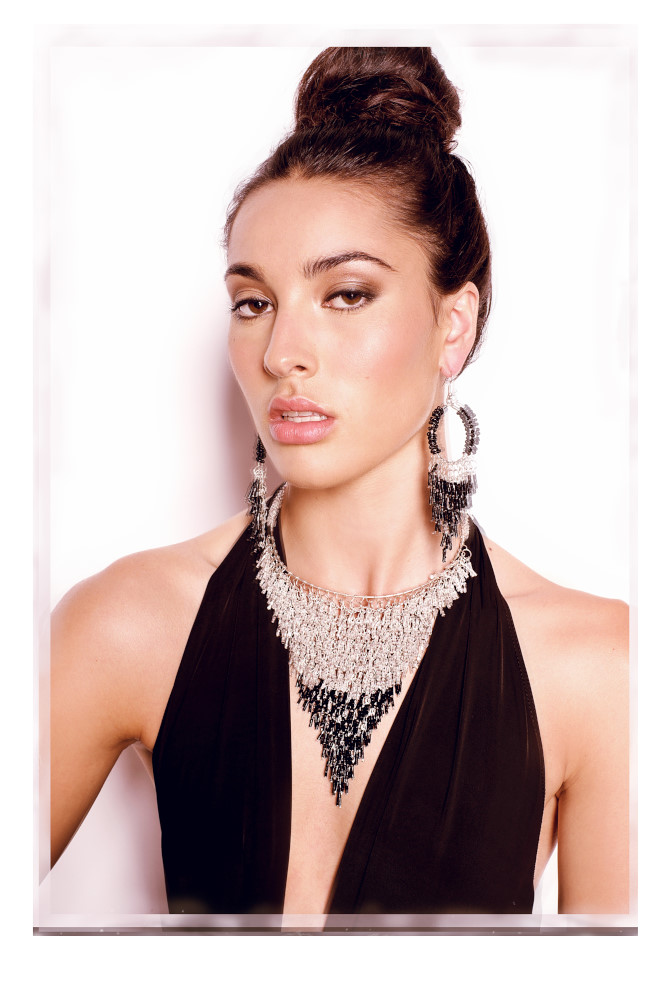 Fashion portrait for a jewellery campaign, model wearing black evening dress with black beaded necklace, braclets and matching earings. Photography by Kent Johnson.