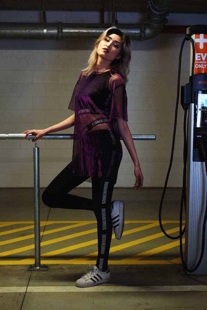 Sheer purple top over sportswear. Parking garage photoshoot in Sydney for Somewhere Label. Photography by Kent Johnson
