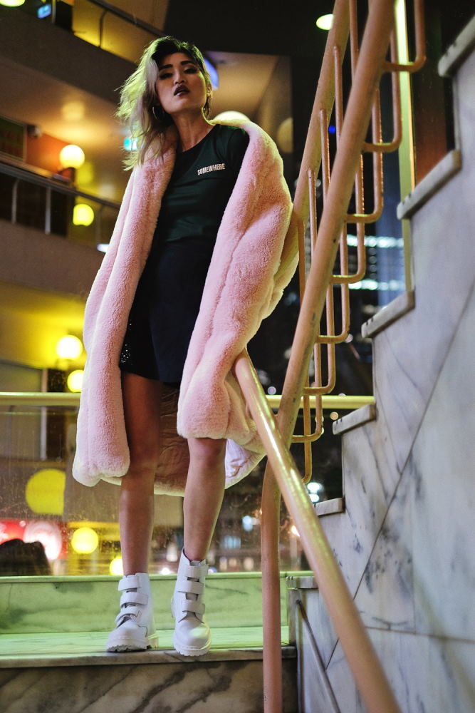 Sydney fashion photographed by Kent Johnson - Night location, model in faux fleece coat on staircase for Somewhere Label.