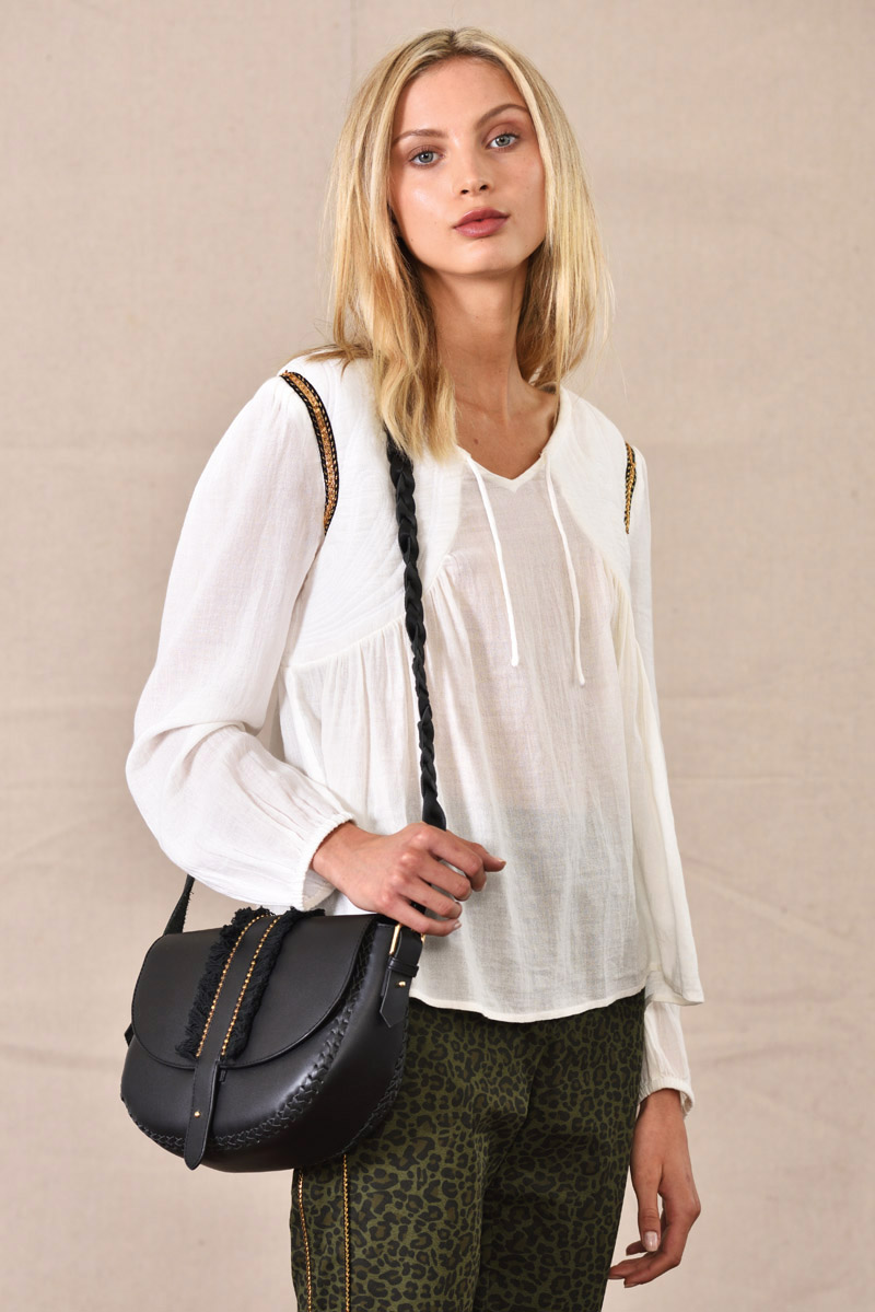 Quilted cotton blouse, black handbag, detailed mid shot - eCommerce Studio Fashion Photography by Kent Johnson. Fashion marketing campaign, model on white background.