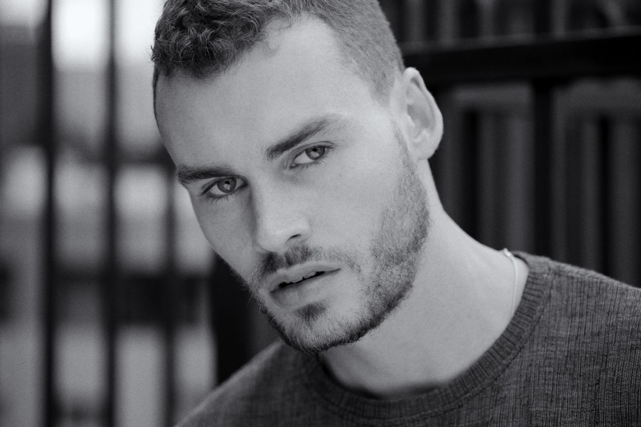 Male model, headshot, close up, horizontal in black and white.