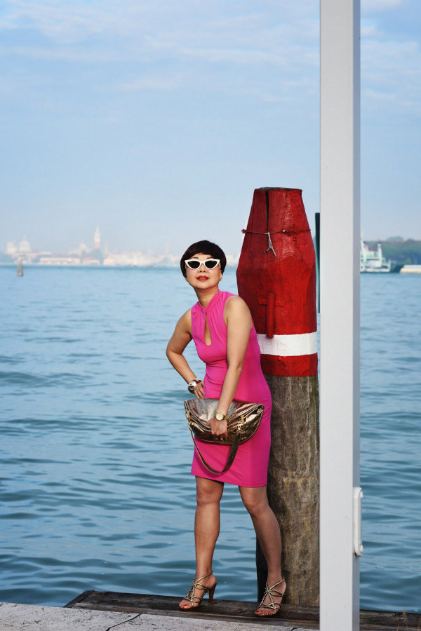 Vivienne in a pink dress at a lagoon filling station, Lido, Venice.