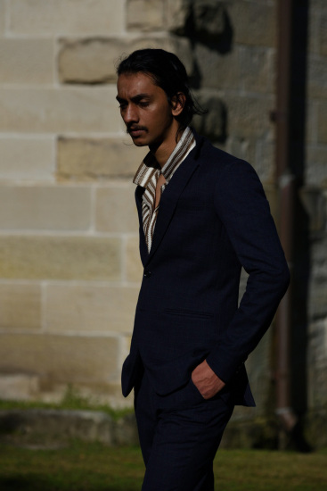 Profile shot, dark suit and striped shirt, on location, Sydney.