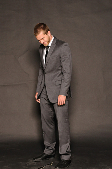 Business suit shot in a casual manner on a black background.