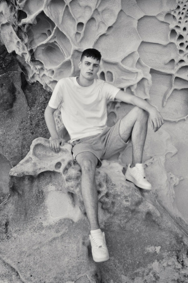 Male modelling. Leo on the beach in late afternooon light, horizontal headshot, Sydney, Australia.