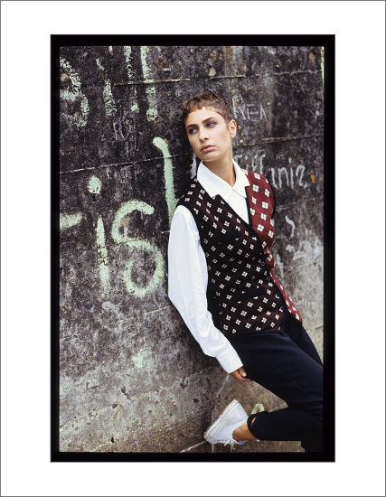 Woman in argyle cardigan over white shirt dark pants, menswear inspired editorial for Mode Magazine, Australia.