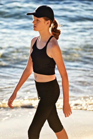 Young model walking on the beach late afternoon.