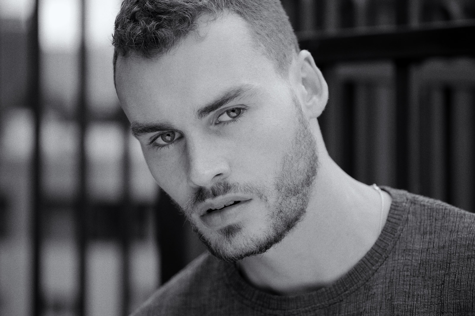 Black and white headshot of a male model in an urban location. Photography by Kent Johnson, Sydney, Australia.