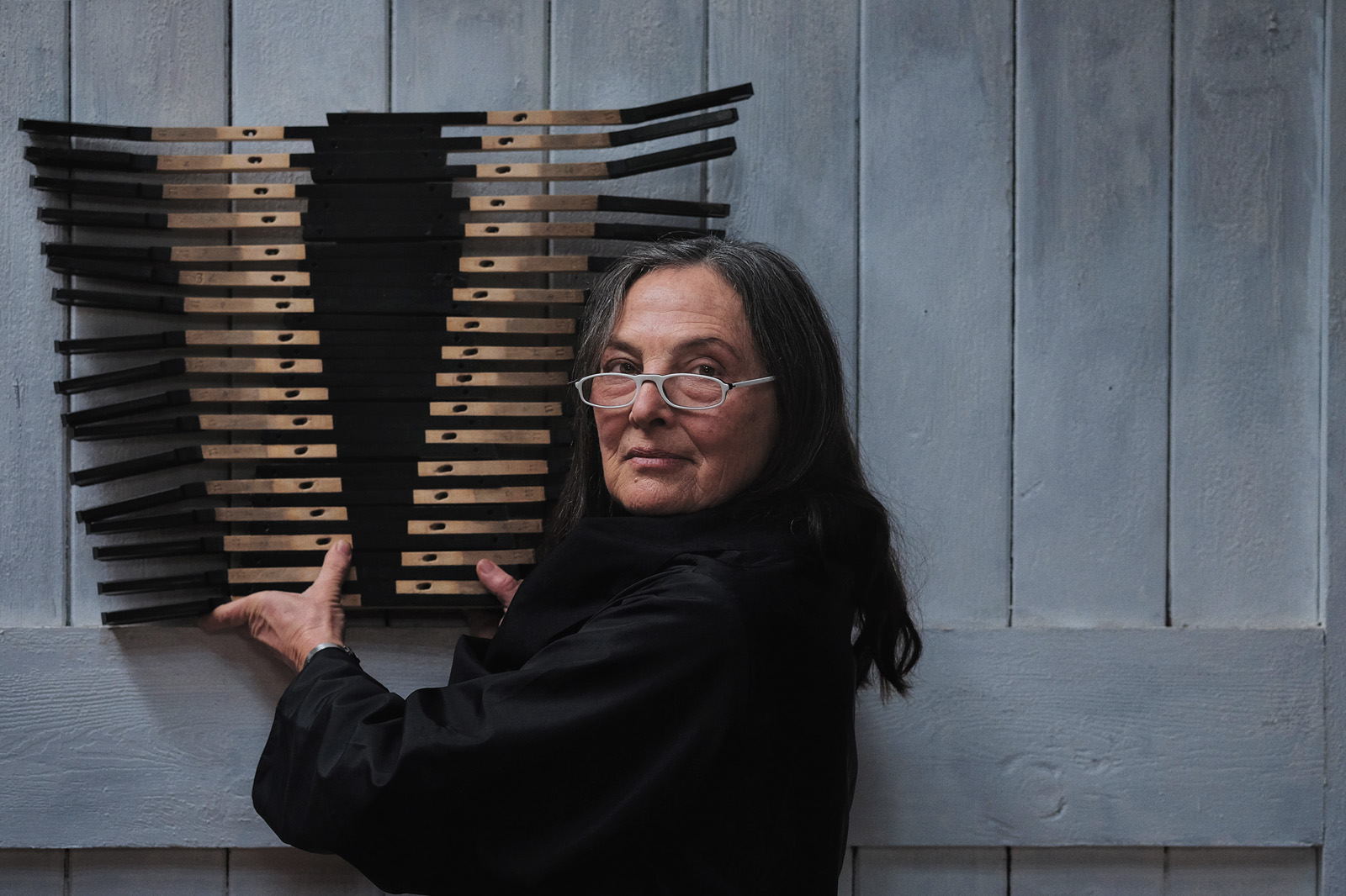Portrait of Australian artist Brenda Stace with artwork in her Nowra studio.