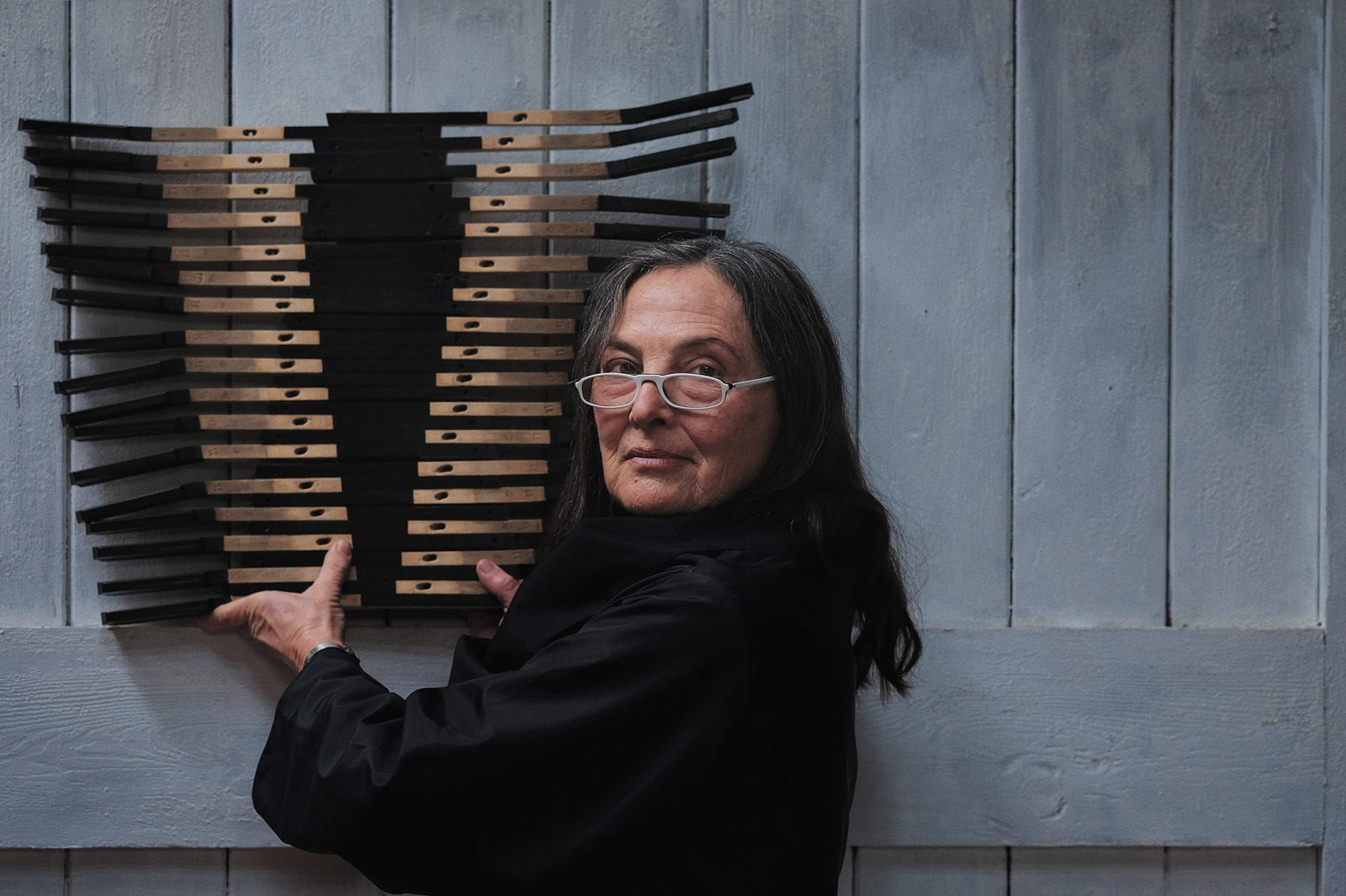 Portrait of Australian artist Brenda Stace with artwork in her Nowra studio.