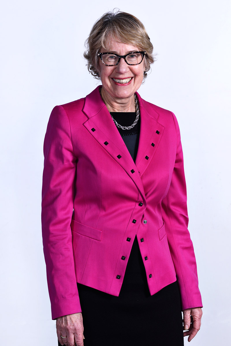 Arts Law Board member, lady in magenta jacket, On-site studio coporate portraiture by Kent Johnson