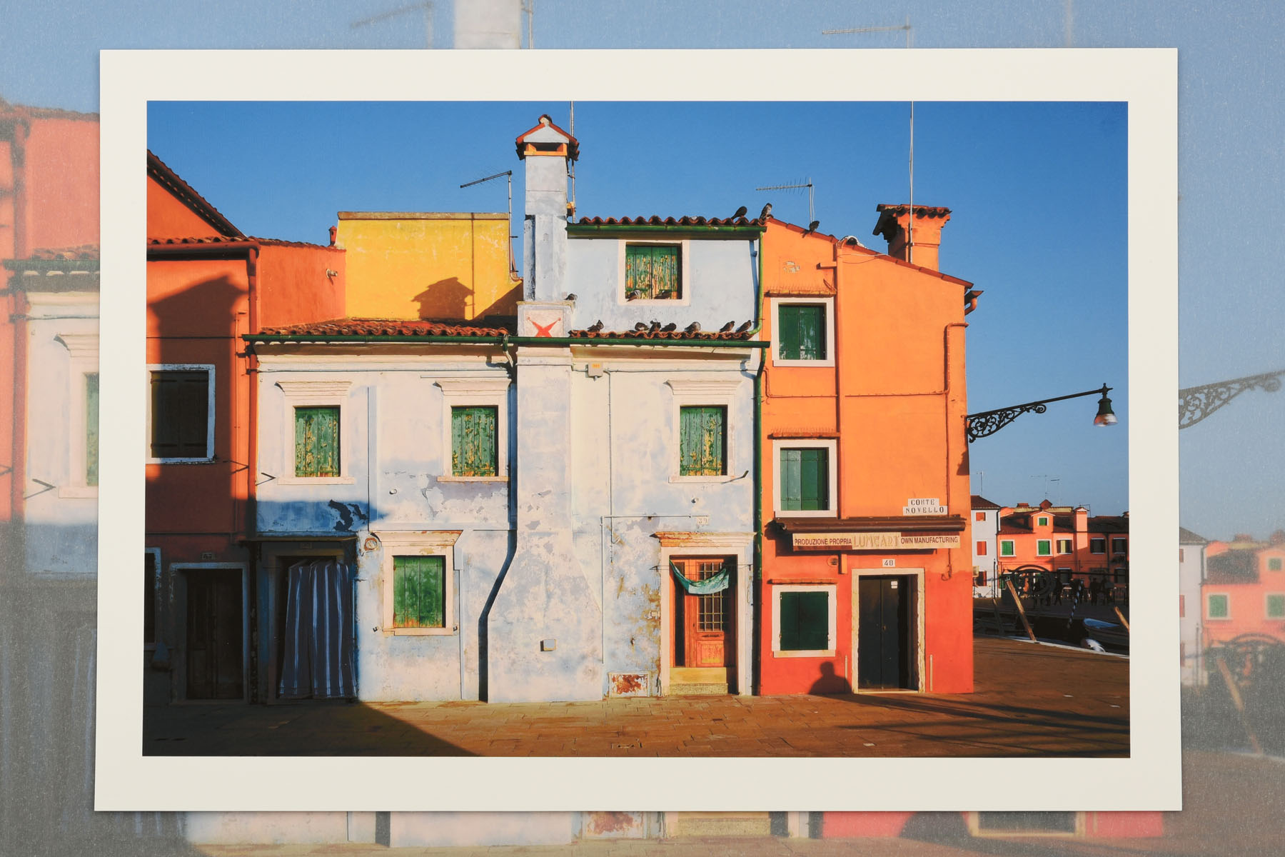 The colourful houses of Burano in early moning light. La Serenissima an exhibition of photographs and fine art prints by Kent Johnson