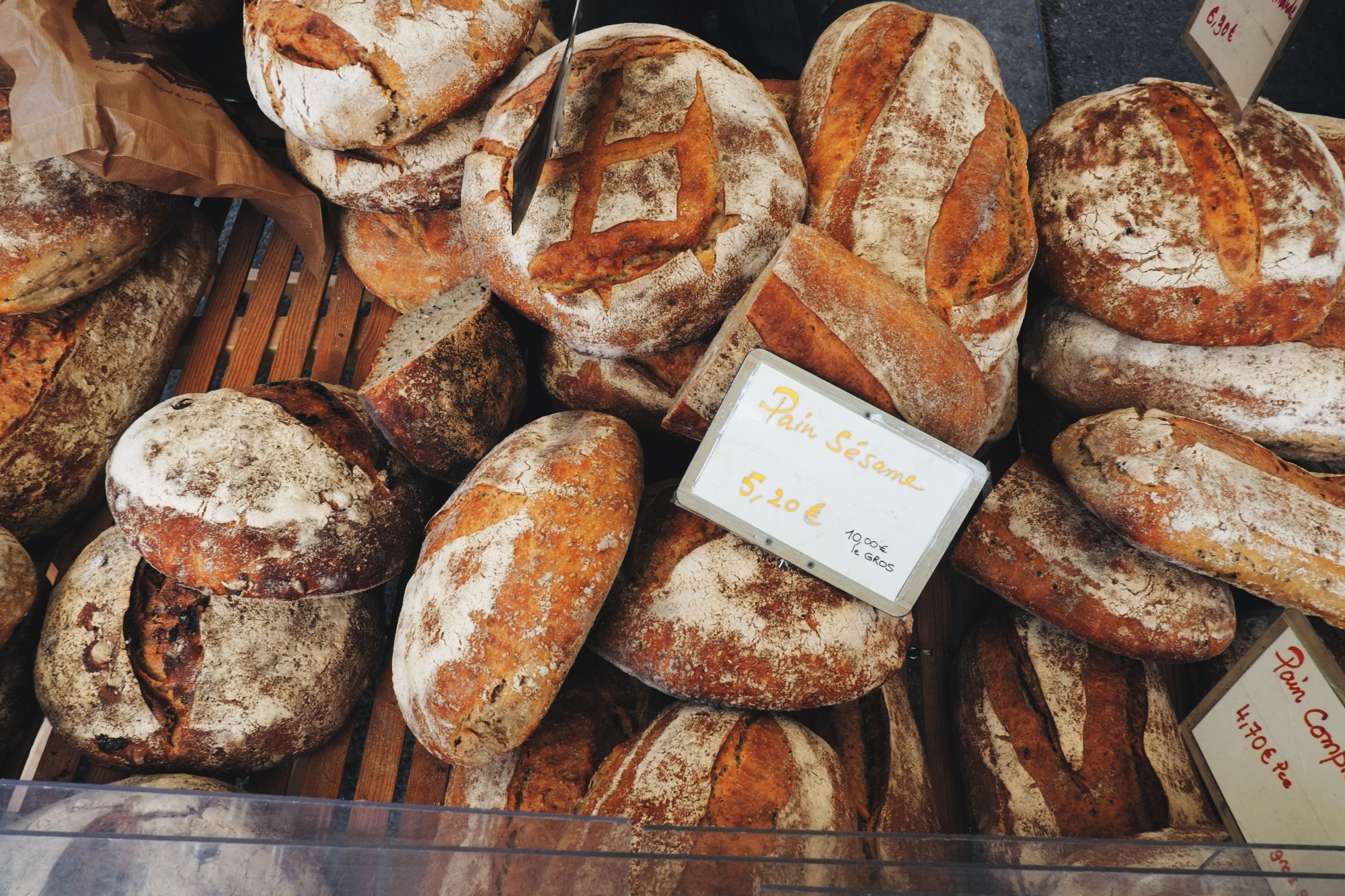 Artisanal bread stall, market day in Le Bois-d'Oingt. Food and travel lifestyle photography by Kent Johnson.