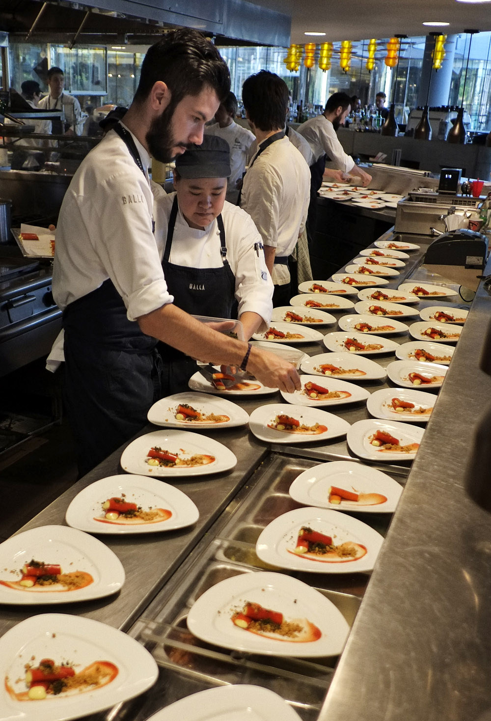 Plating the Tomato Cannoli With Saffron Crème e Fiordilatte gelato by Danny Russo of Russonlini. Photographed by Kent Johnson.