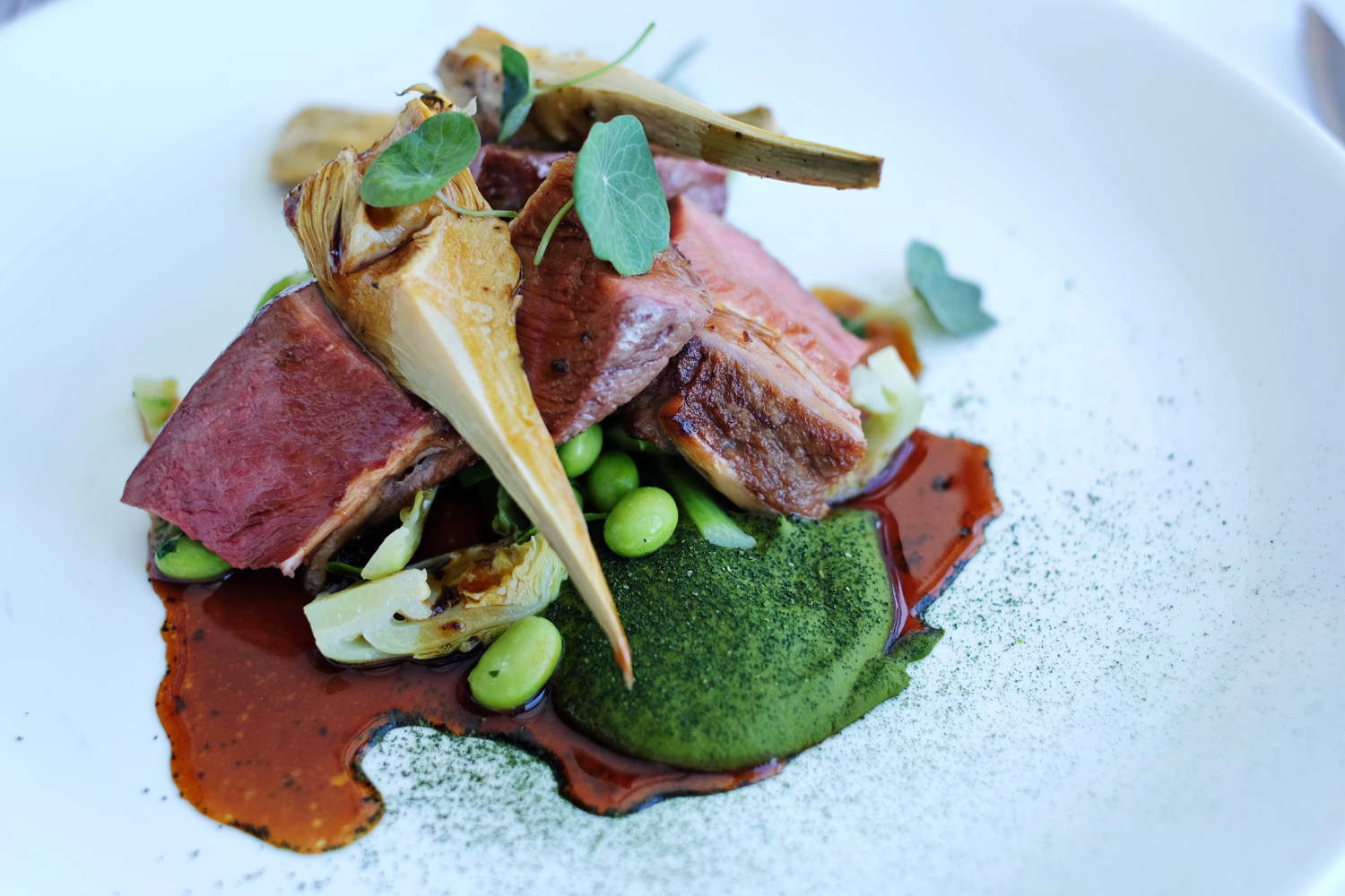 Roasted Lamb Loin, Brussel Sprouts, Poached Artichoke & Black Garlic Sauce - Icebergs Dining Room And Bar - Bondi Beach, Sydney, Australia.  Photography by Kent Johnson for White Caviar Life.