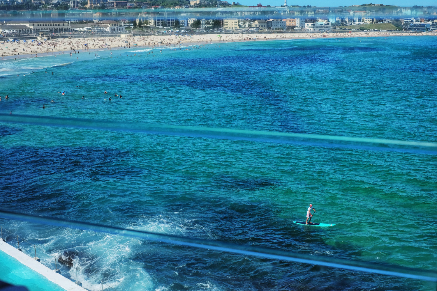 The blue bay and a view back to the beach - Icebergs Dining Room And Bar - Bondi Beach, Sydney, Australia. Photography by Kent Johnson