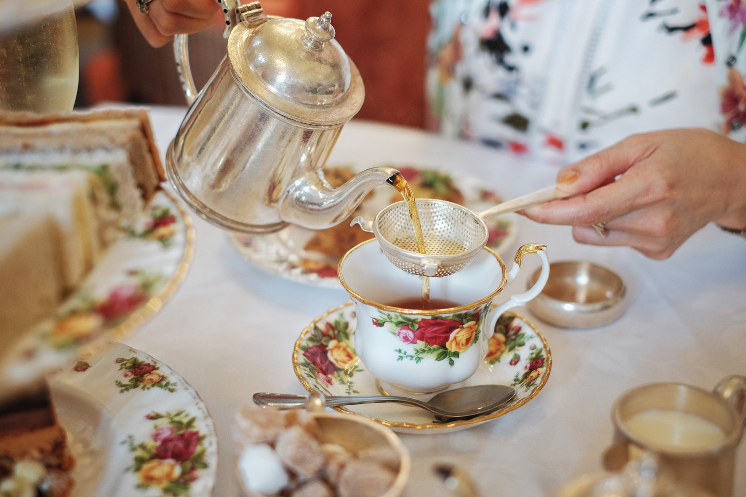pouring tea from a sliver tea pot at Queen Victoria Tea Room - Sydney, Australia