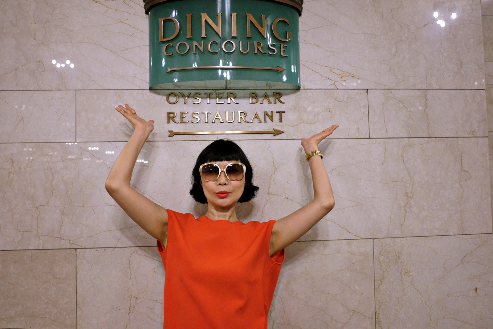 Vivienne poses under the Oyster Bar Seafood Restaurant sign, Grand Central Terminal, New York City