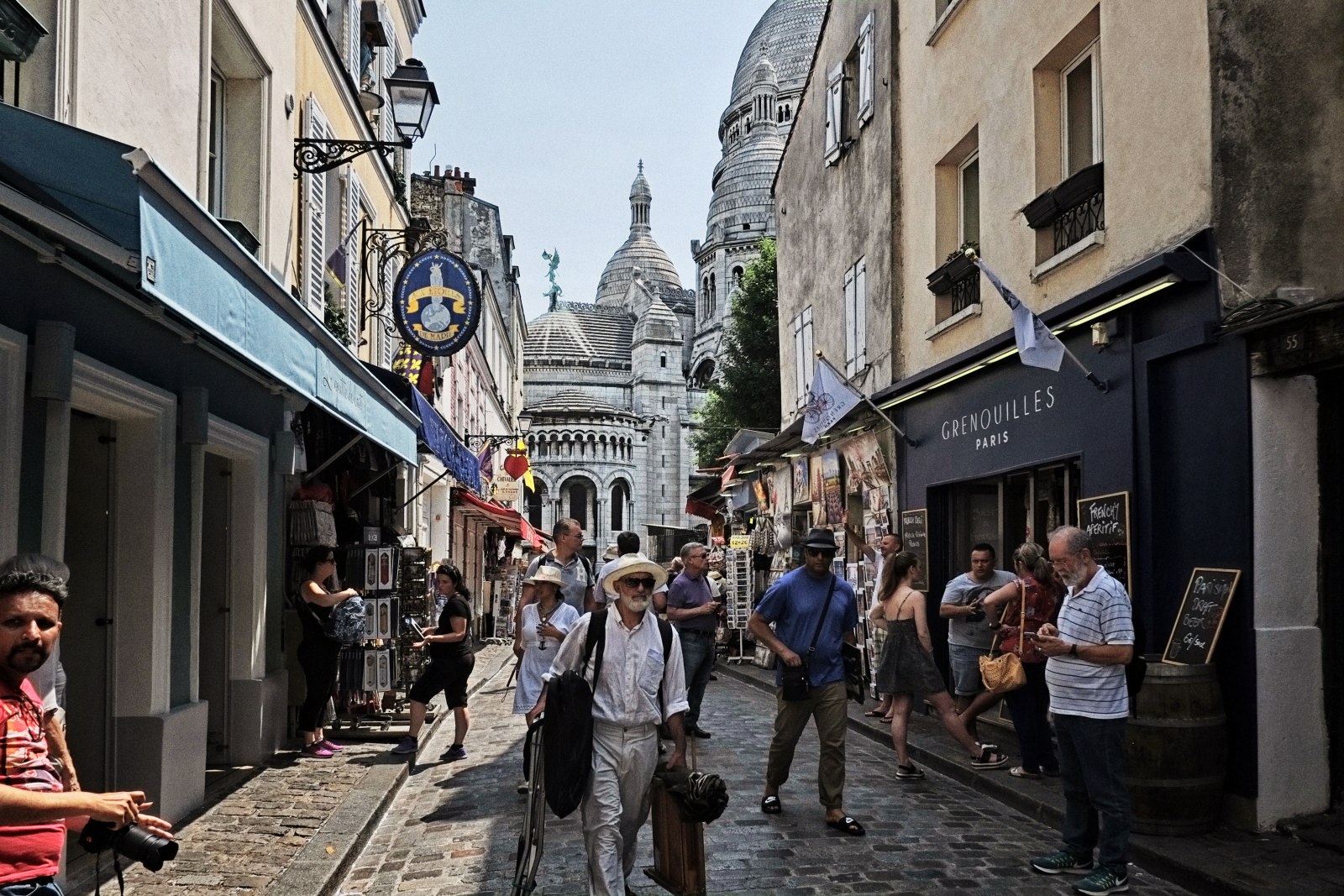 A street scene, Rue du Chevalier de la Barre and Sacré-Cœur, Montmartre, Paris. Street style travel photography by Kent Johnson.