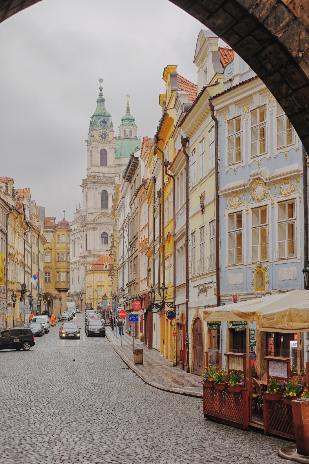 St. Nicholas Church Kostel sv. Mikuláše, and historic apartment houses, viewed from Mostecká street. Travel photography by Kent Johnson.