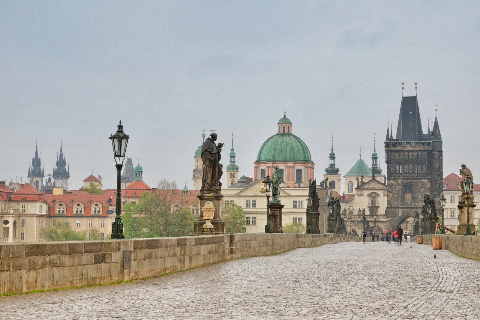 Early morning on Charles Bridge - Karlův most, statues, spires and domes of Prague's old town. Travel photography by Kent Johnson.