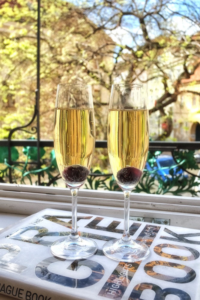 Two glasses of champagne on the balcony of our Prague hotel. Travel photography by Kent Johnson.