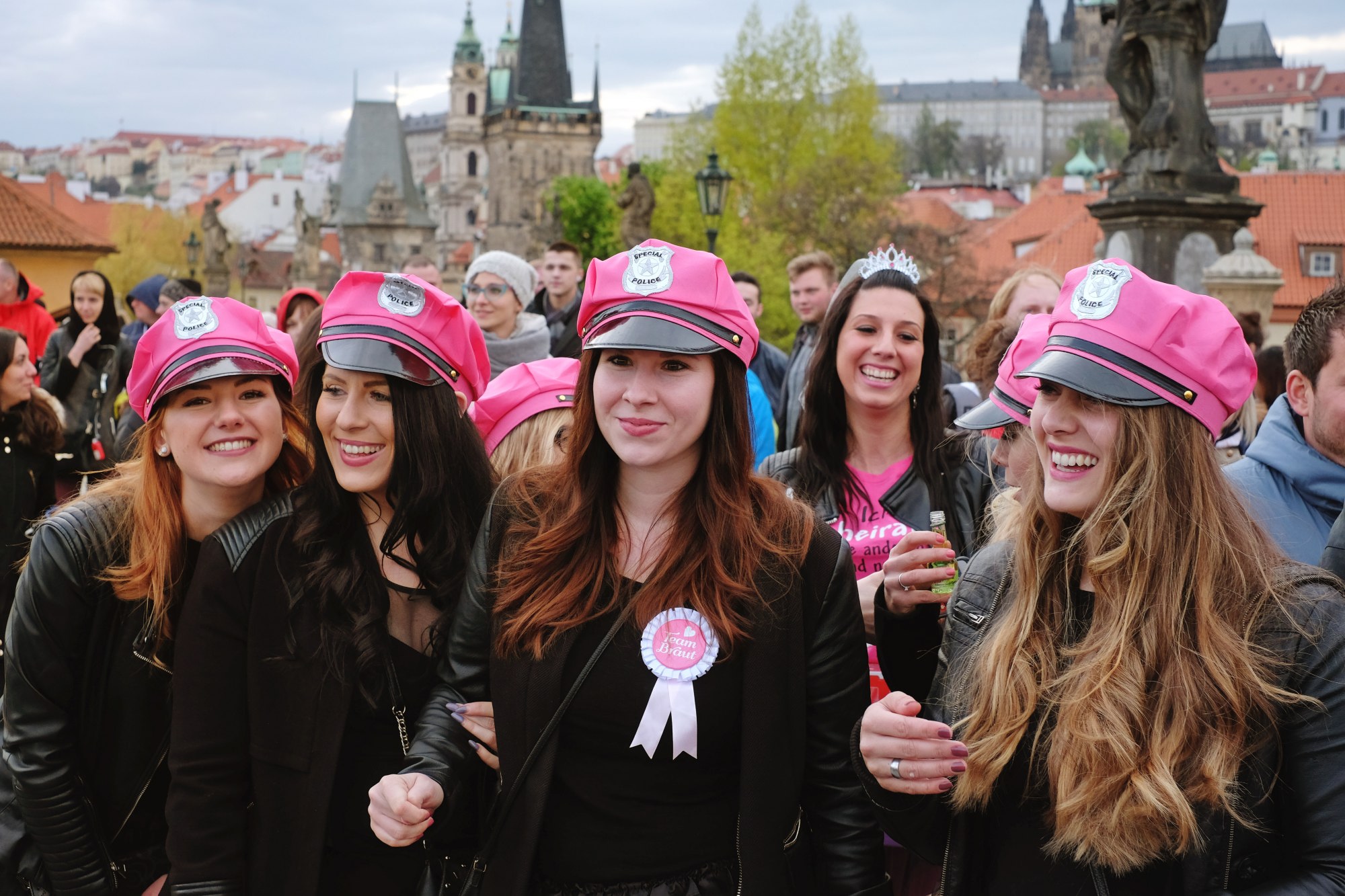 Special Police, Friends of the Bride; hens party in pink police caps on the Charles Bridge in Prague. Travel photography by Kent Johnson.