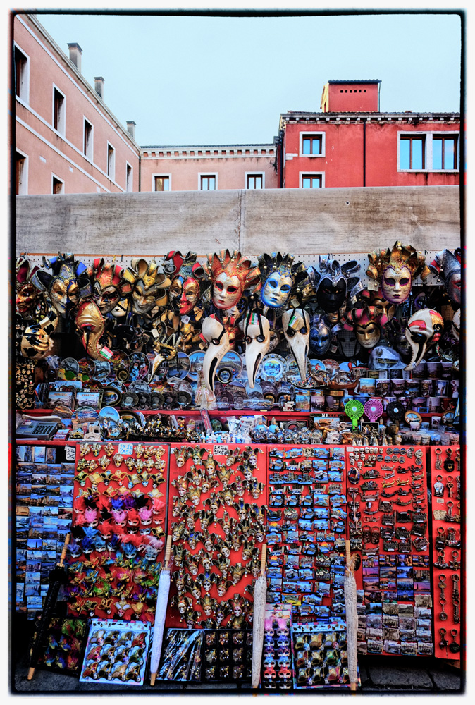Souvenir stall with Venitian carnval masks, Rialto. Travel photography by Kent Johnson.