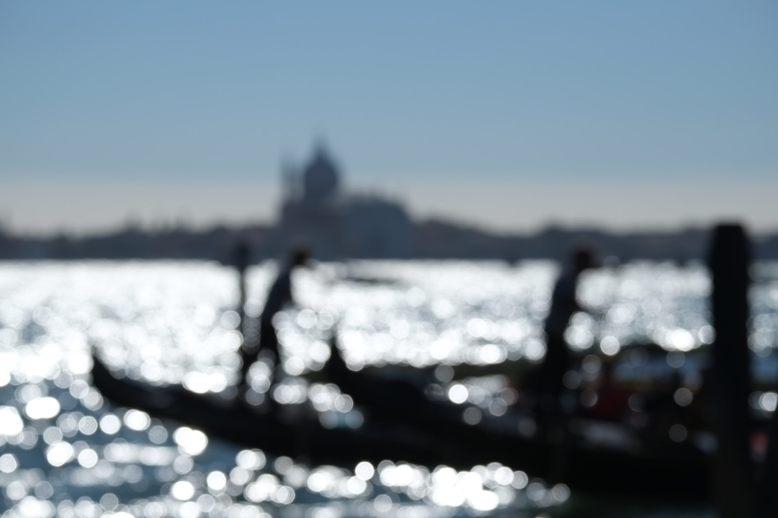 Rings of light dissolve the gondolas on St Marks basin, Venice