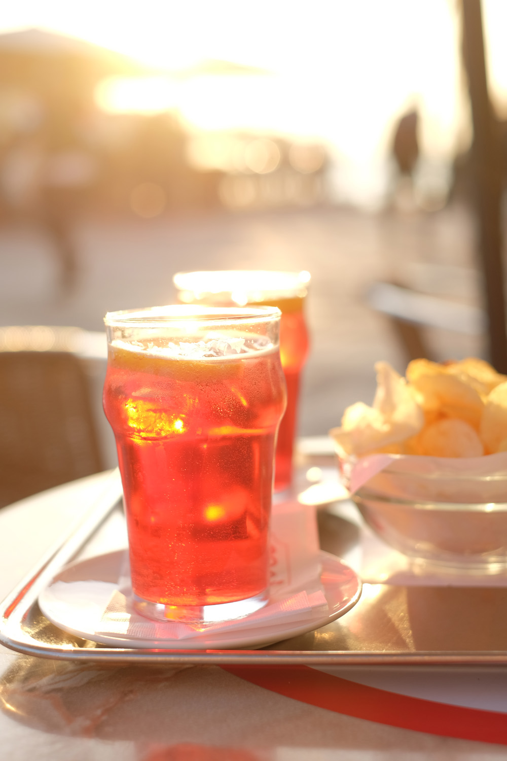 A sunset aperitivo on Dorsoduro, Campari spritz and crisps. Travel and food photography by Kent Johnson.
