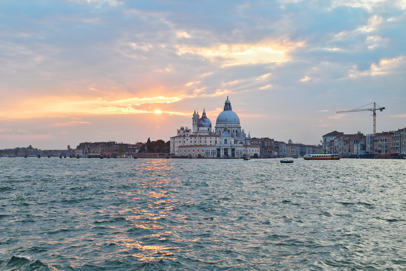 Nearly sunset, Punta della Dogana and Basilica di Santa Maria della Salute seen from on the water of St Marks Basin, Venice